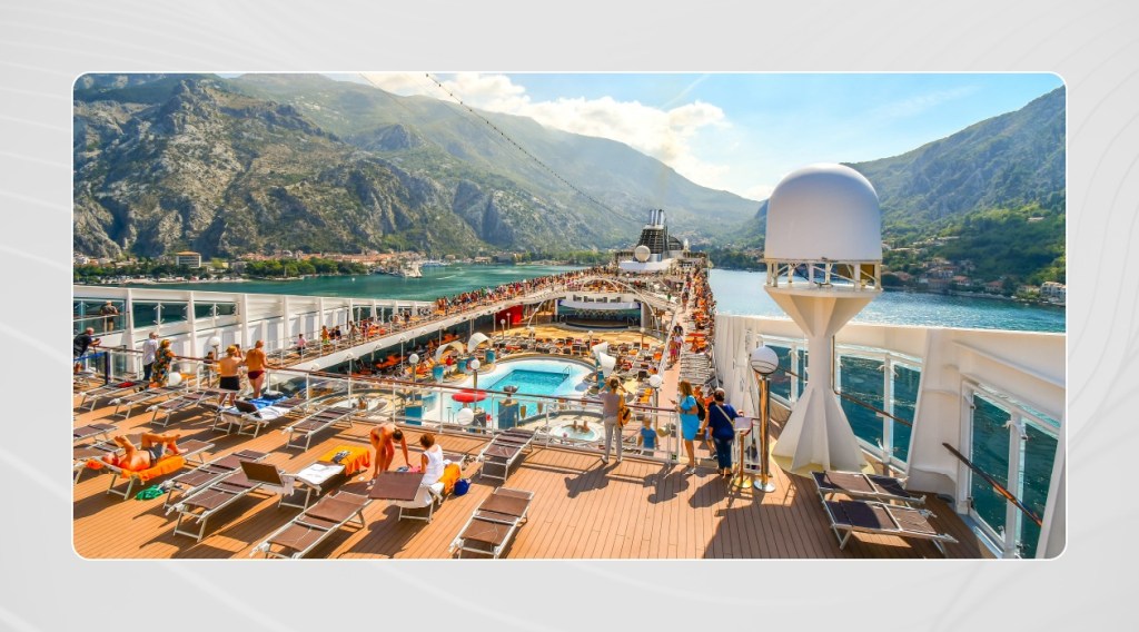 people smiling while watching a performance on a cruise ship
